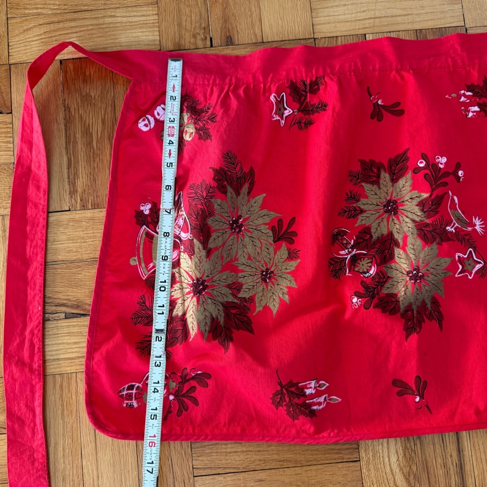 Vintage Christmas print cotton apron, gold poinsetta print on red background.
